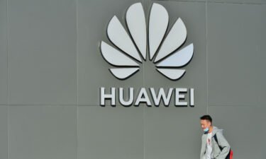 A man walks past a Huawei store on October 12