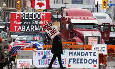 A protester walks in front of parked trucks in Ottawa as demonstrations continue over vaccine mandates and coronavirus restrictions on February 8.