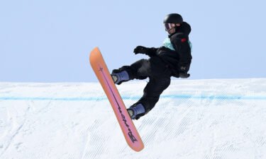 China's Su Yiming performs a trick during the men's snowboard big air final on Day 11 of the Beijing Winter Olympics.