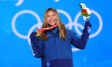 Chloe Kim poses with her medal after winning the women's snowboard halfpipe event.