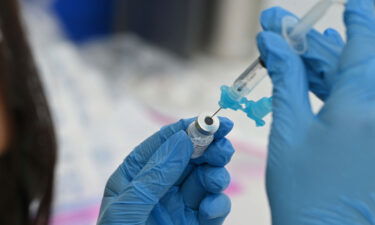 A healthcare worker fills a syringe with Pfizer Covid-19 vaccine at a community vaccination event in a predominately Latino neighborhood in Los Angeles in 2021.