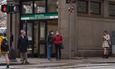 A growing number of states and major cities are lifting Covid-19 restrictions. Pictured are commuters outside a subway station in downtown Boston