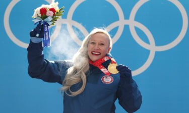 Kaillie Humphries poses after winning gold for Team USA at Beijing 2022.