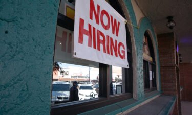 A "Now Hiring" sign outside a restaurant in Huntington Park