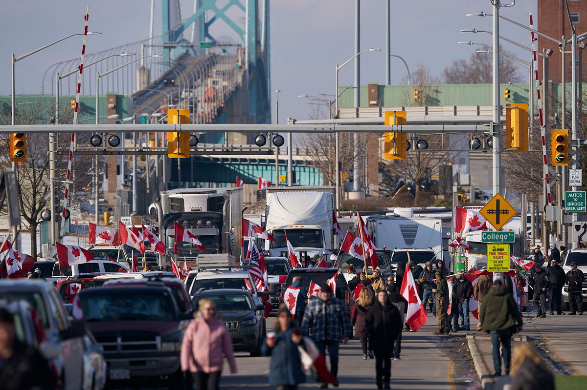 <i>Geoff Robins/AFP/Getty Images</i><br/>Protestors against Covid-19 vaccine mandates block the roadway at the Ambassador Bridge border crossing in Windsor