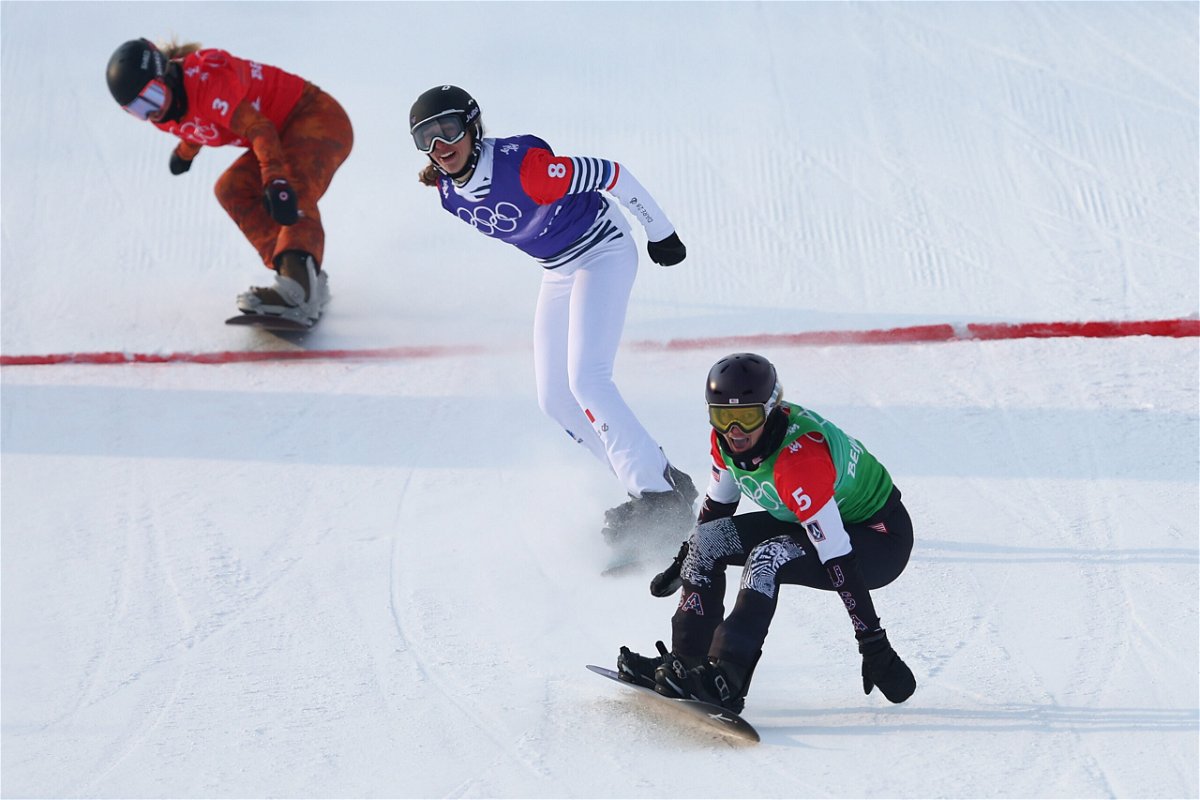 <i>Clive Rose/Getty Images</i><br/>Jacobellis crosses the finish line to win the gold medal during the women's snowboard cross big final.