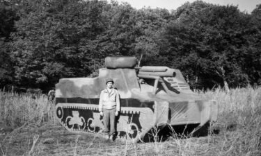 An unknown "Ghost Army" soldier of the 23rd Headquarters Special Troops is pictured before an inflatable M7 Priest self-propelled gun on September 14