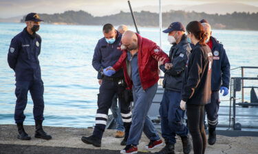 A rescued passenger arrives at the port of Corfu on Friday