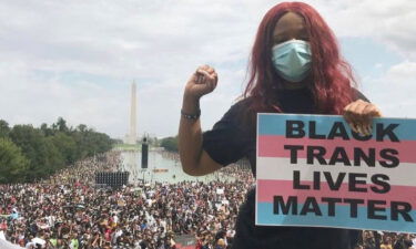 Nupol Kiazolu holds a  Black Trans Lives Matter sign on August 28
