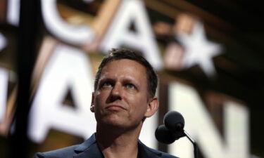 Billionaire tech investor Peter Thiel looks over the podium before the start of the second day session of the Republican National Convention in Cleveland