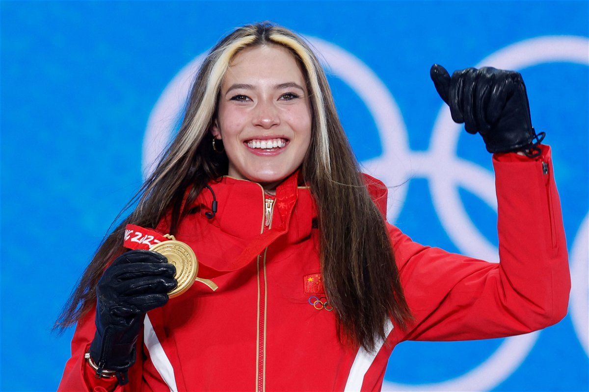 <i>Odd Anderson/AFP/Getty Images</i><br/>Gold medalist Eileen Gu celebrates on the podium after winning the freestyle skiing women's halfpipe.