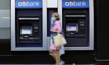 A pedestrian wearing a protective mask walks past a Citigroup Inc. Citibank bank branch in New York