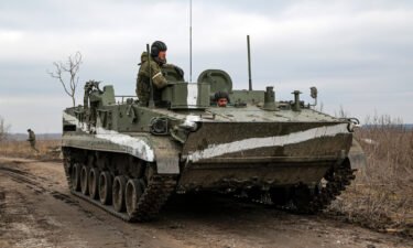 An armored vehicle rolls outside Mykolaivka