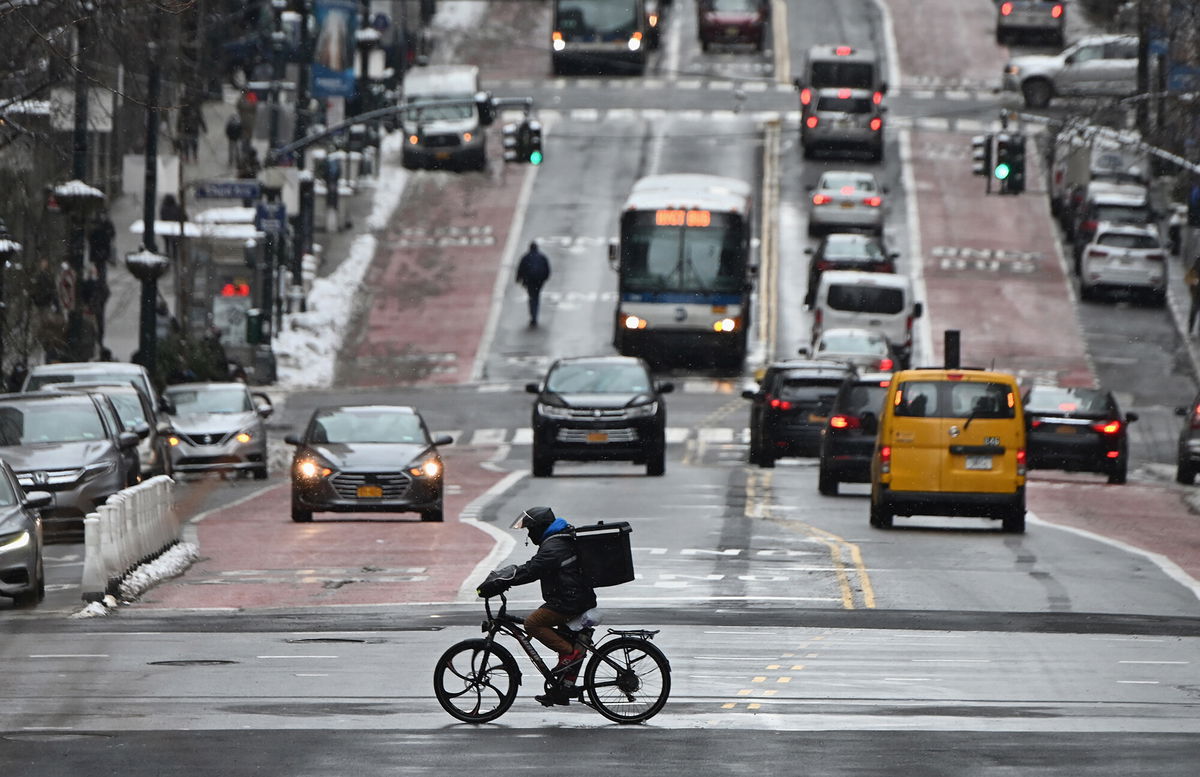 <i>Angela Weiss/AFP/Getty Images</i><br/>A man on a delivery bike rides in the street after a winter storm hit New York City