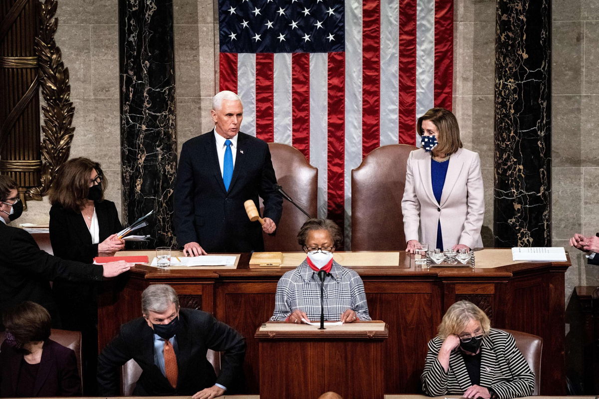 <i>Erin Schaff/Pool/AFP/Getty Images</i><br/>Vice President Mike Pence and House Speaker Nancy Pelosi preside over a Joint session of Congress to certify the 2020 Electoral College results after supporters of President Donald Trump stormed the Capitol earlier in the day on Capitol Hill in Washington