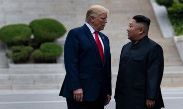 Then-President Donald Trump and North Korea's leader Kim Jong-un stand on North Korean soil while walking to South Korea in the Demilitarized Zone in June 2019. Some records involving correspondence with Kim were among those sought by the Archives.