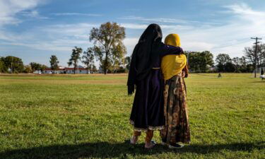 Afghan refugee girls watch a soccer match near where they are staying in the Village at the Ft. McCoy U.S. Army base on September 30