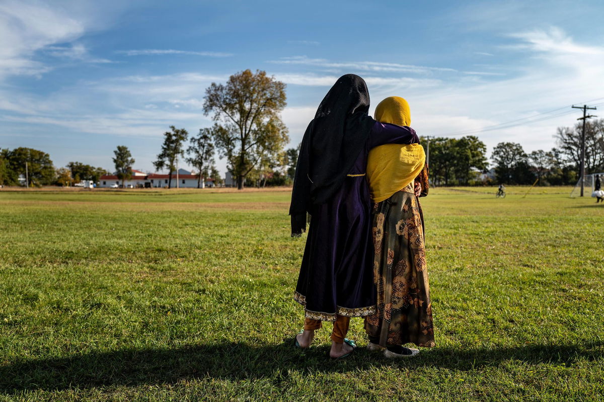 <i>Barbara Davidson/Getty Images</i><br/>Afghan refugee girls watch a soccer match near where they are staying in the Village at the Ft. McCoy U.S. Army base on September 30