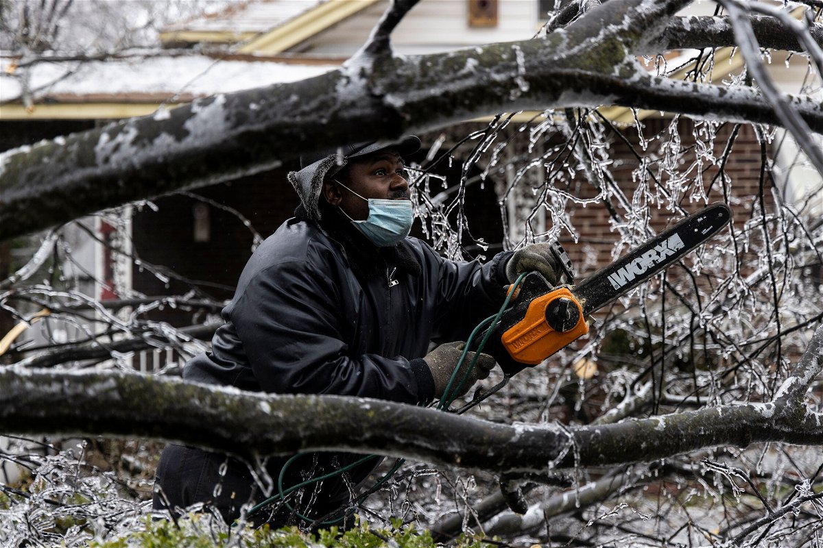 <i>Brad Vest/Getty Images</i><br/>A man works to clear a downed tree on February 3 in Memphis