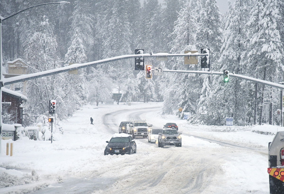 <i>Elias Funez/The Union/AP</i><br/>A vehicle is stuck in the snow during a winter storm on December 27 in Grass Valley