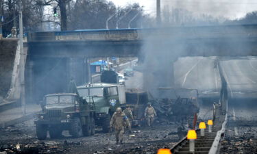 Ukrainian service members are seen at the site of fighting with a Russian raiding group in Kyiv on the morning of February 26