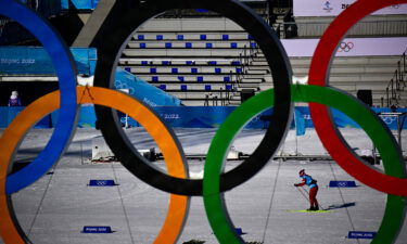 An athlete is pictured through the Olympic rings while training during a practice session on February 3