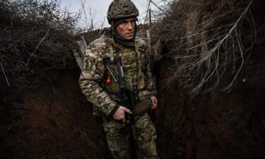 Ukrainian troops patrol outside the town of Novoluhanske