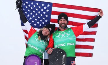 Gold medalists Lindsey Jacobellis and Nick Baumgartner of Team United States celebrate during the mixed team snowboard cross flower ceremony on Day 8 of the Beijing 2022 Winter Olympics on February 12.