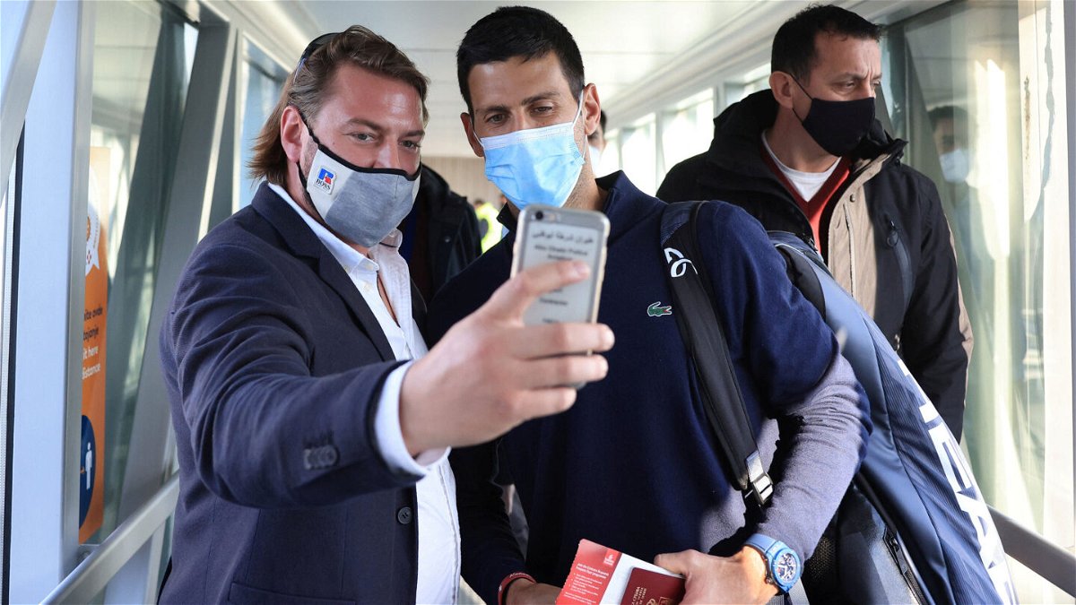 <i>Christopher Pike/Reuters</i><br/>A man takes a selfie with Djokovic as he arrives at Nikola Tesla Airport in Belgrade
