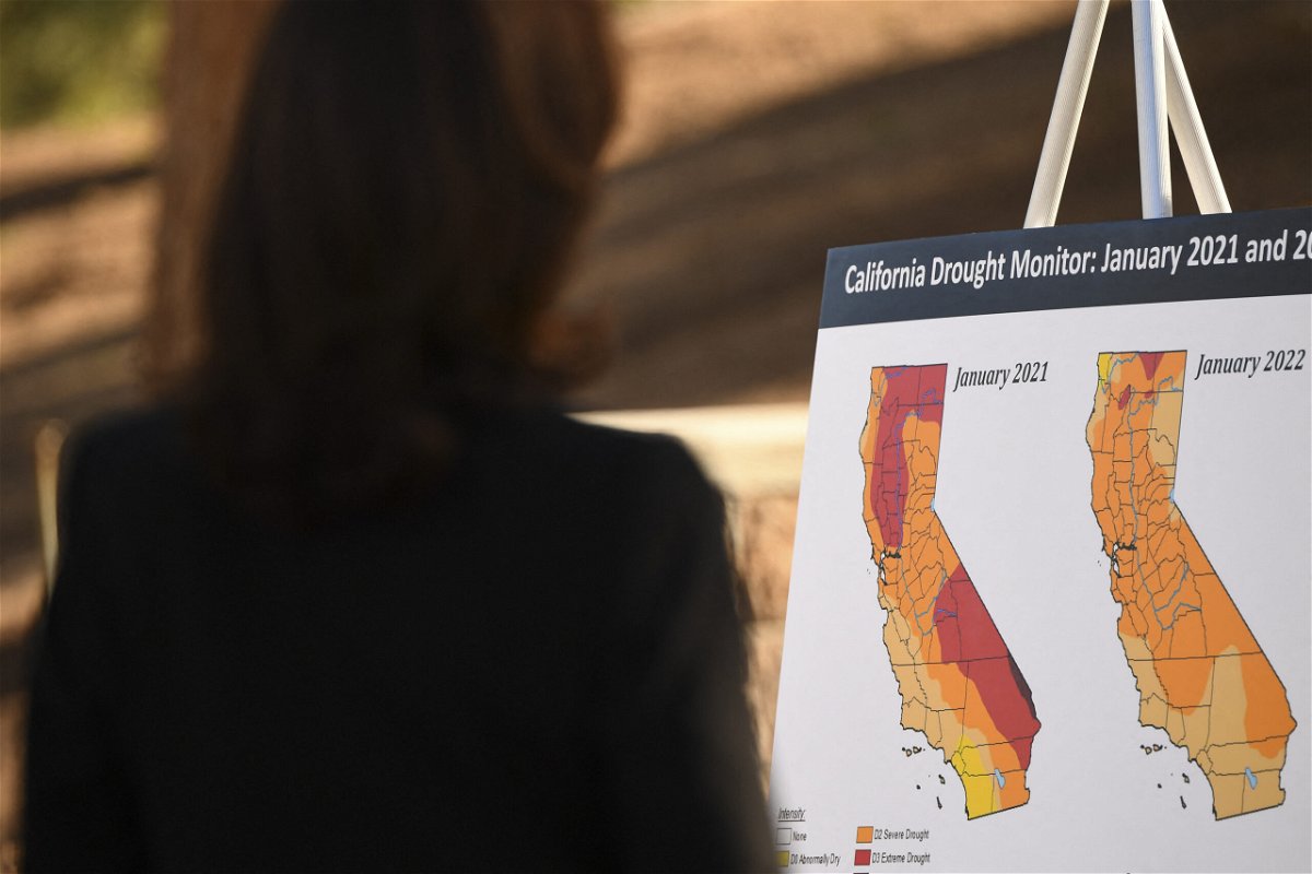 <i>PATRICK T. FALLON/AFP/Getty Images</i><br/>Vice President Kamala Harris reads a briefing poster about drought conditions at the US Forest Service Del Rosa fire station in San Bernardino