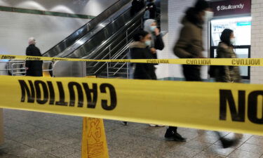 People walk through a subway station in Manhattan