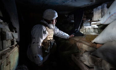 A Ukrainian soldier surveys the area from his position outside of Donetsk