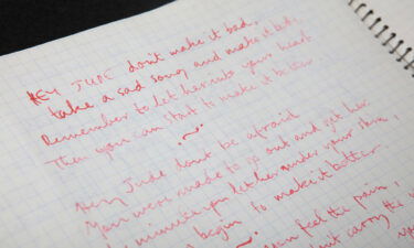 The notebook contains Paul McCartney's handwritten draft lyrics to the 1968 song "Hey Jude."