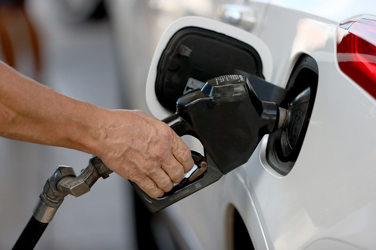 <i>Joe Raedle/Getty Images</i><br/>A customer pumps gas into his vehicle at a Shell station in 2021 in Miami.