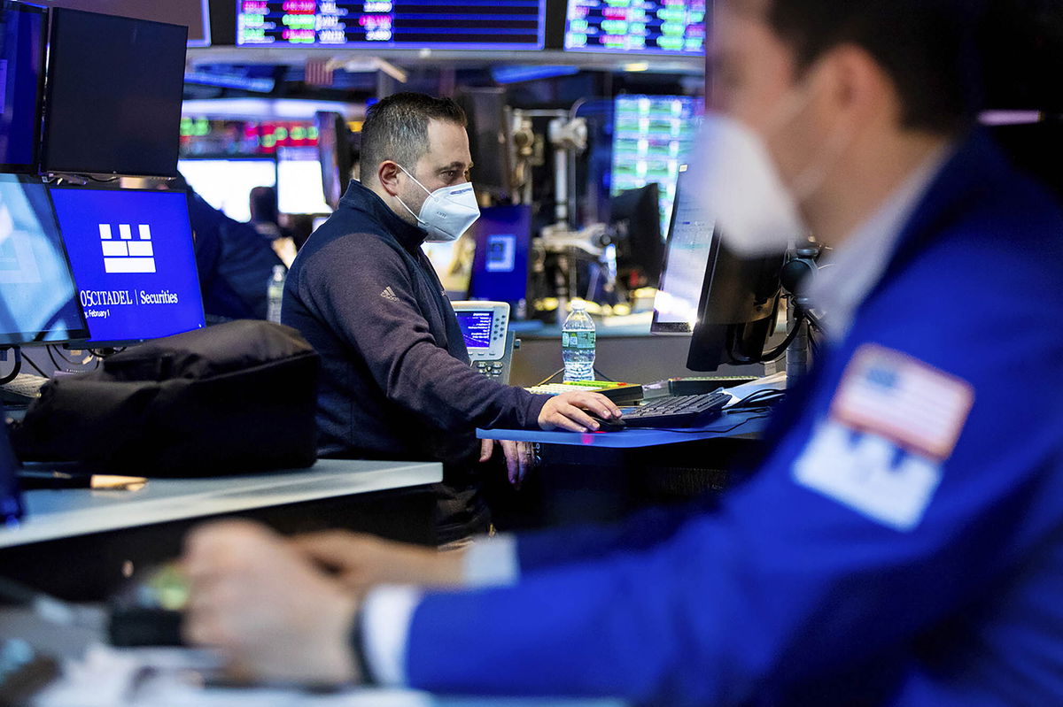 <i>Allie Joseph/New York Stock Exchange/AP</i><br/>Specialists work on the trading floor