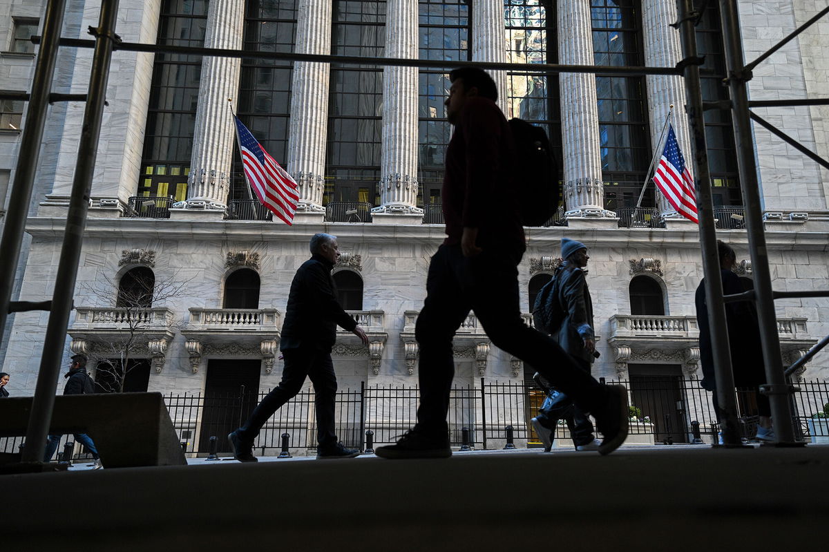 <i>Erik Pendzich/Shutterstock</i><br/>People walk past the New York Stock Exchange (NYSE) on Wall Street on February 11