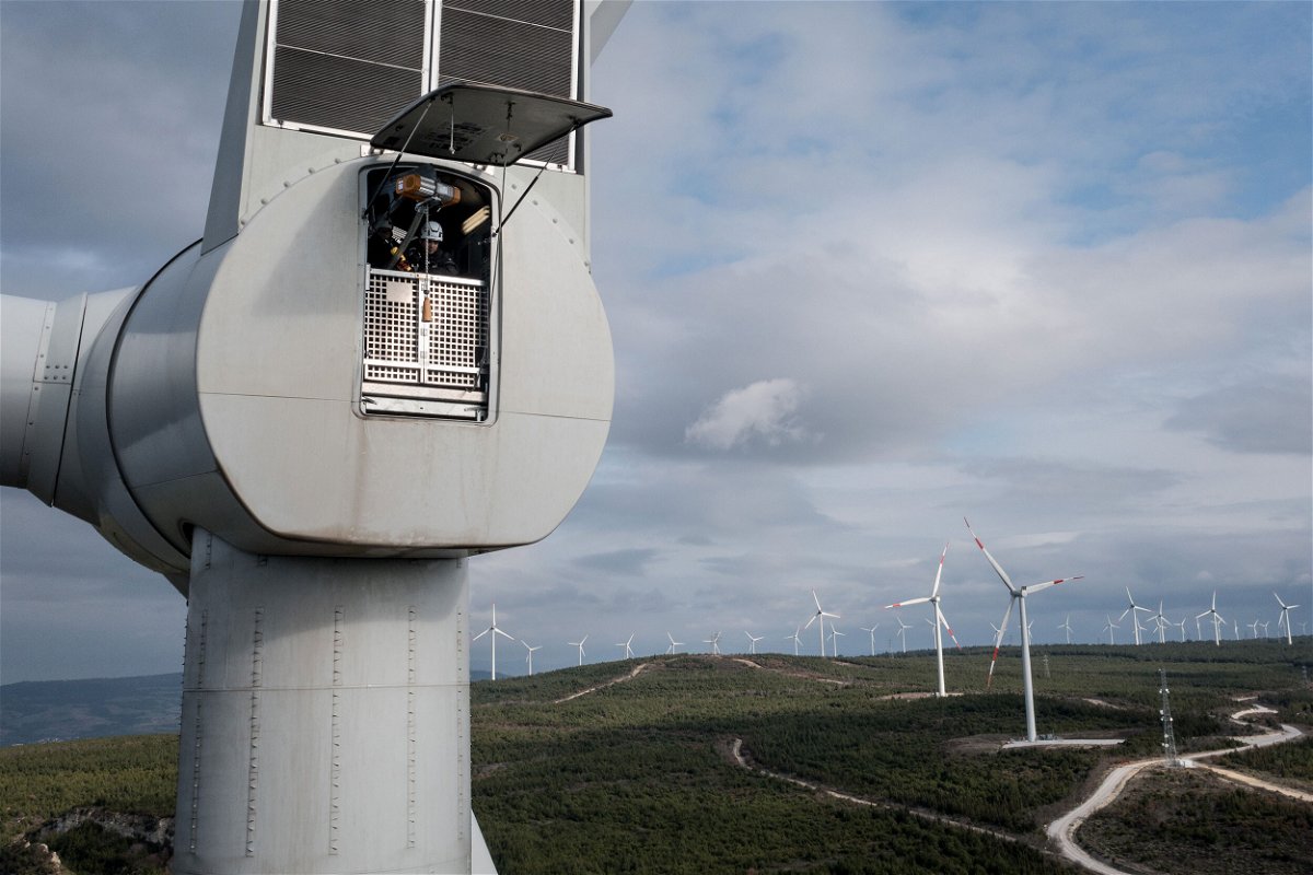 <i>Chris McGrath/Getty Images</i><br/>Employees from Akfen Renewable Energy Group's Canakkale Wind Power Plant in Turkey do a routine maintenance check of equipment on the top of a wind turbine in December 2021.