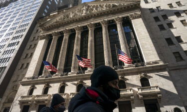 A pedestrian passes the New York Stock Exchange