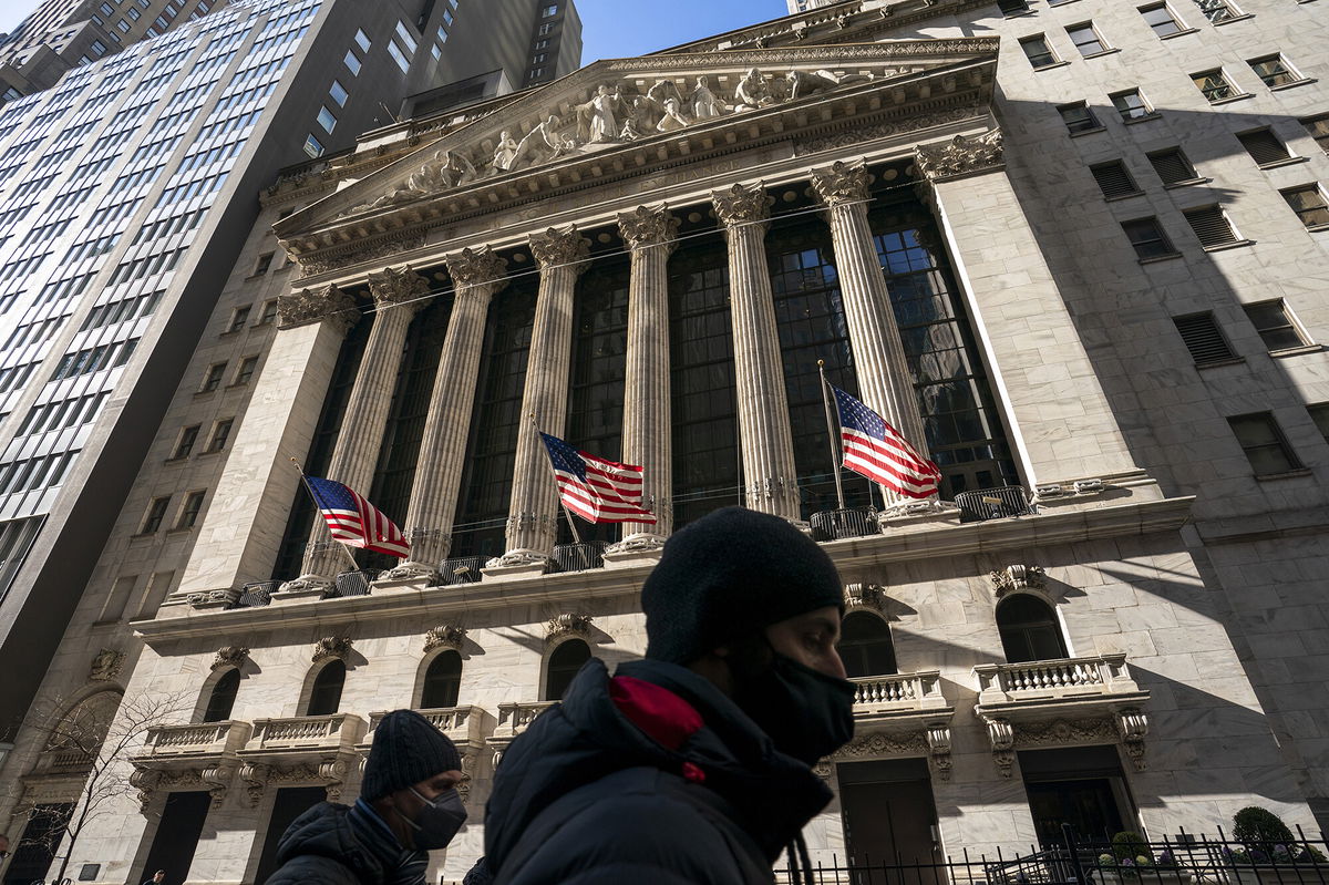 <i>John Minchillo/AP</i><br/>A pedestrian passes the New York Stock Exchange