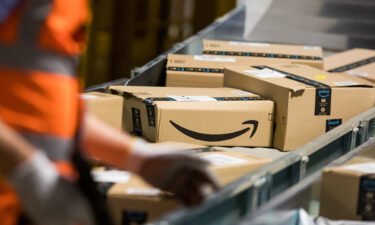 Packages sit on a conveyor belt at an Amazon fulfillment center. Amazon is raising the price of its annual Prime subscriptions from $119 to $139 per year in the United States