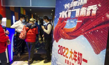 People walk past a poster of "The Battle at Lake Changjin II" at a cinema on February 1
