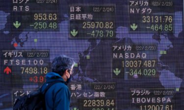 A man walks past an electronic stock exchange board displaying Japan's Nikkei stock index in downtown Tokyo. Japan's Nikkei index fell below 26