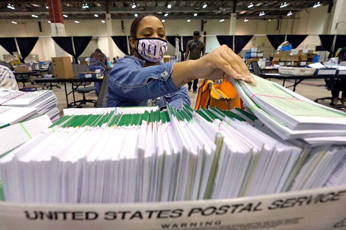 <i>David J. Phillip/AP/FILE</i><br/>A federal judge blocks counties from charging Texas officials with crimes for encouraging mail-in voting. Pictured is a Harris County election worker preparing mail-in ballots on September 29