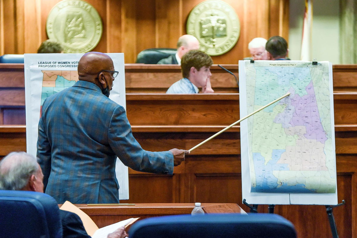 <i>Mickey Welsh/The Montgomery Advertiser/AP</i><br/>Sen. Rodger Smitherman compares US Representative district maps during the special session on redistricting at the Alabama Statehouse in Montgomery