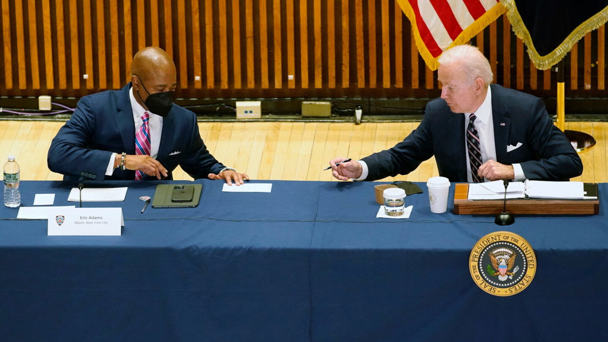 <i>Alex Brandon/AP</i><br/>President Joe Biden hands a note to New York City Mayor Eric Adams during a discussion on gun violence strategies