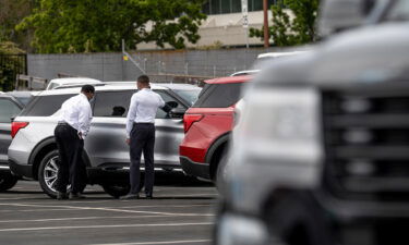 Customers view a vehicle for sale at a Ford Motor Co. dealership in Richmond