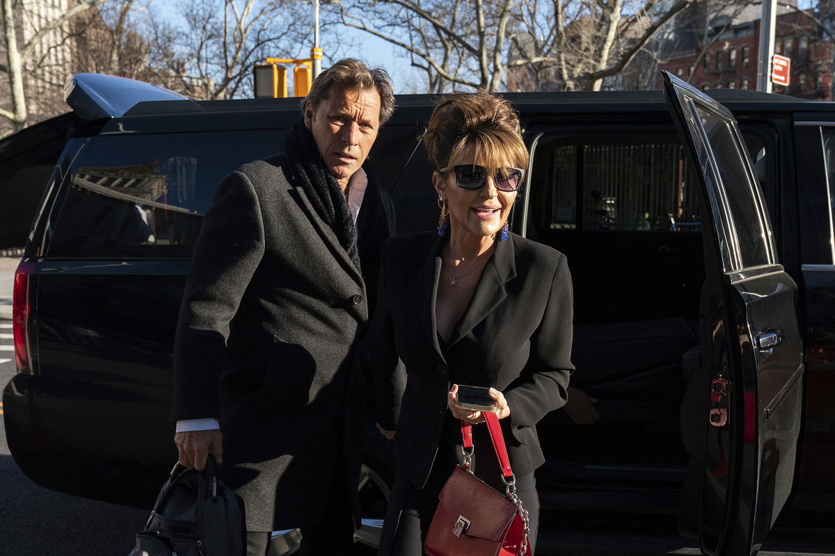 <i>Jeenah Moon/AP</i><br/>Former Alaska Governor Sarah Palin arrives at federal court with former NHL hockey player Ron Duguay in New York on Friday