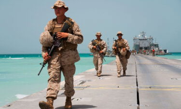 US Marines walk to an American ship docked near a military base in the UAE during a March 2020 exercise.