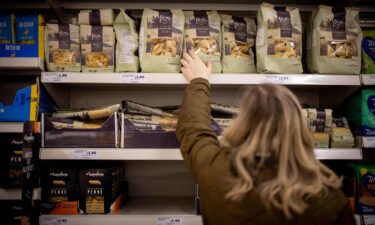 A customer shops for pasta at a Sainsbury's supermarket in Walthamstow