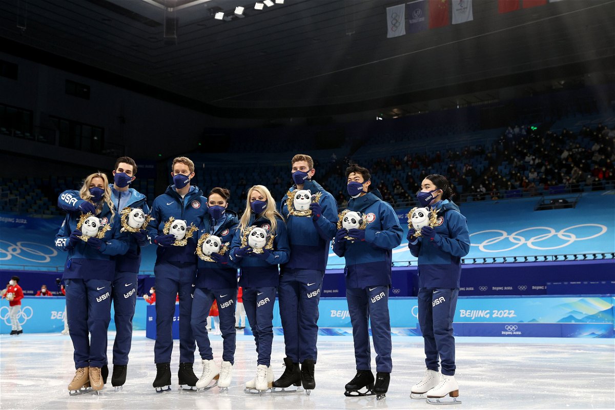 <i>Catherine Ivill/Getty Images</i><br/>Silver medalists Team USA pose during the team event flower ceremony.